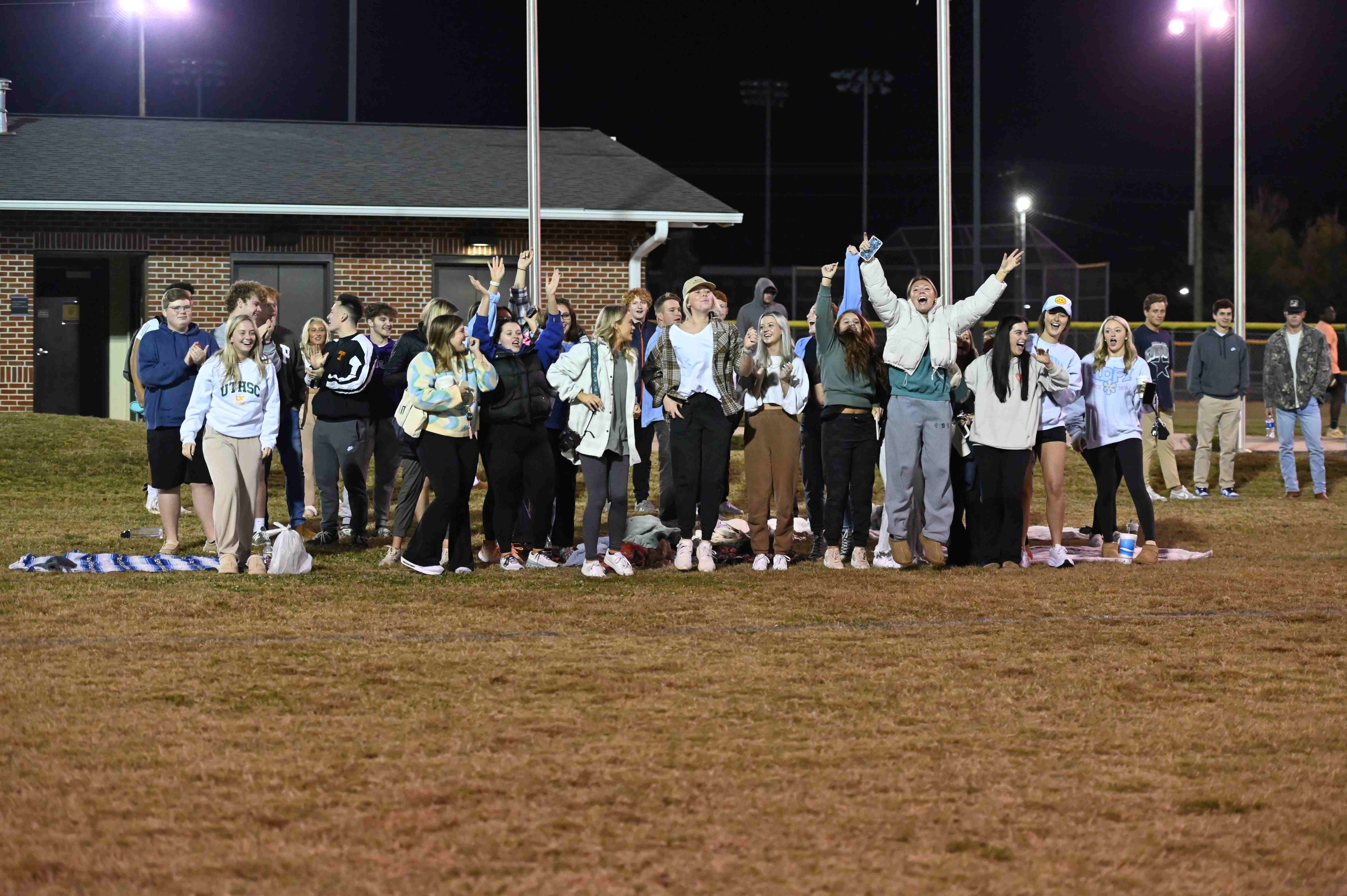 Students cheering during a flag football game.