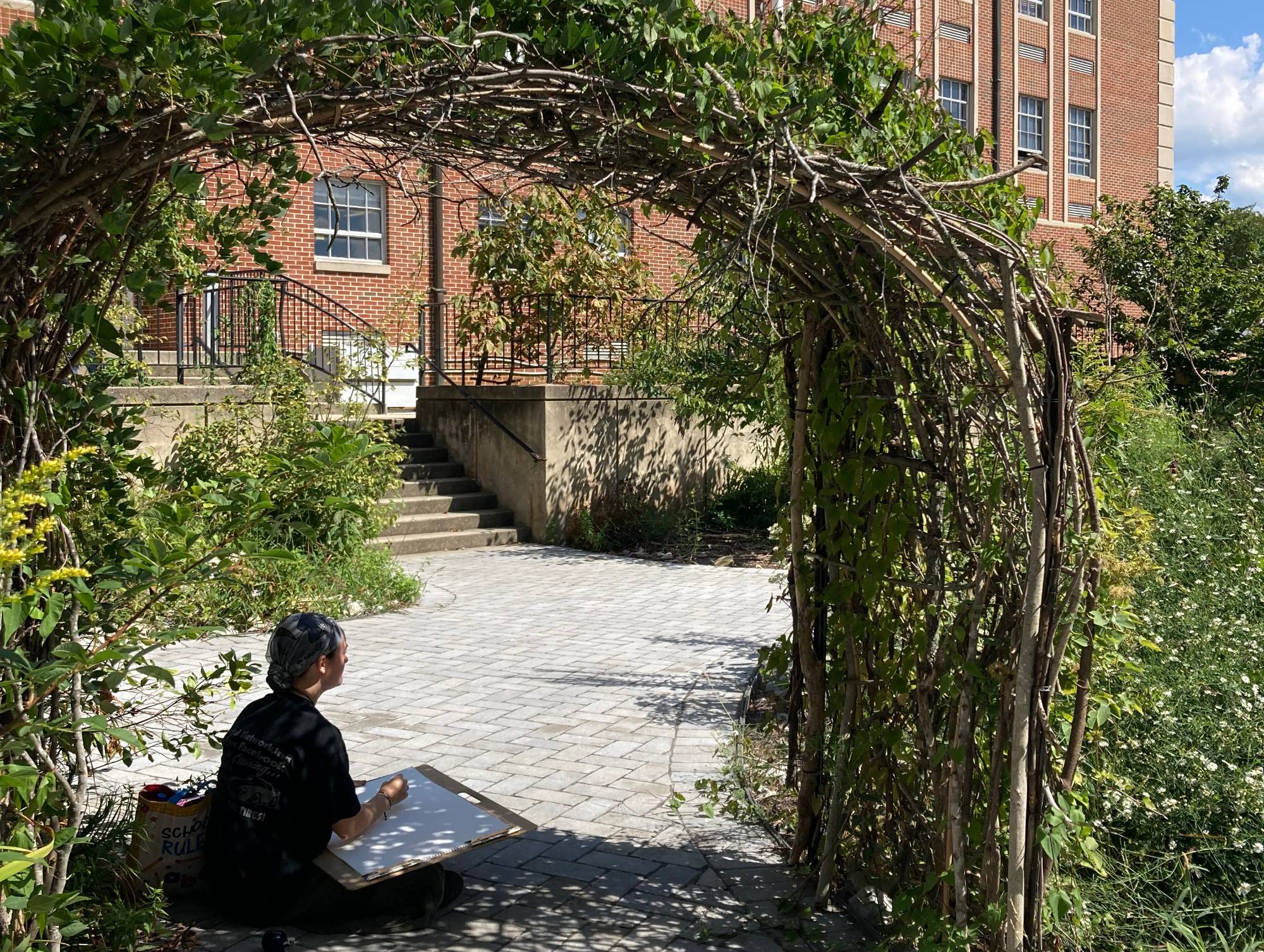 Student drawing in the garden