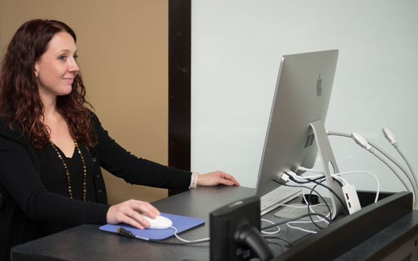 Graduate Student works with technology.