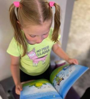 A little girl reading.