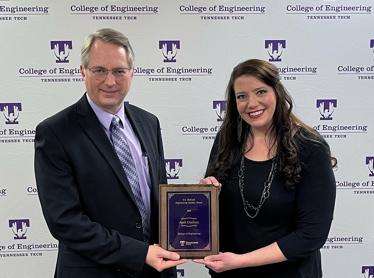 College of Engineering Dean Joseph C Slater presents the T.S. McCord Innovation and Techno- Entrepreneurship Award for 2021 plaque to April Crockett.