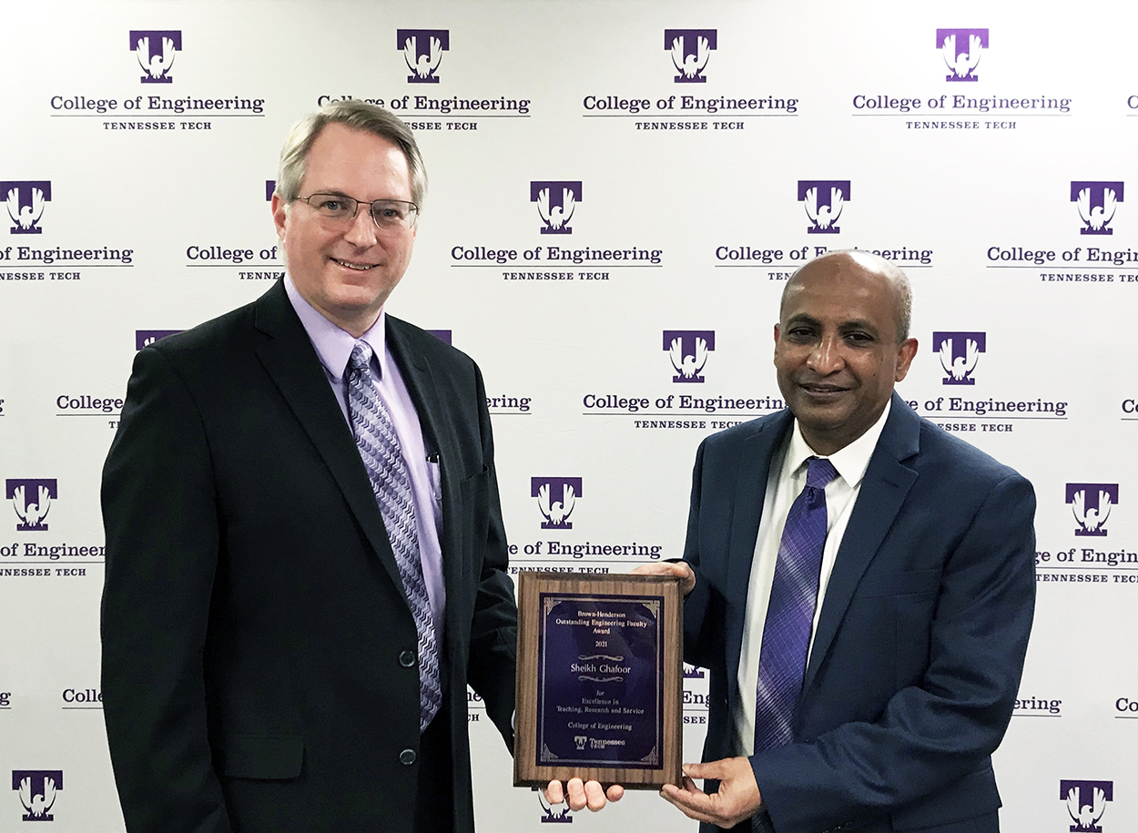 College of Engineering Dean Joseph C Slater presents the Brown-Henderson Award for 2021 plaque to Sheikh Ghafoor for 2021