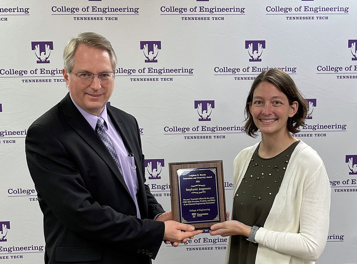 College of Engineering Dean Joseph C Slater presents the Leighton E. Sissom Innovation and Creativity Award for 2021 plaque to Stephanie Jorgensen