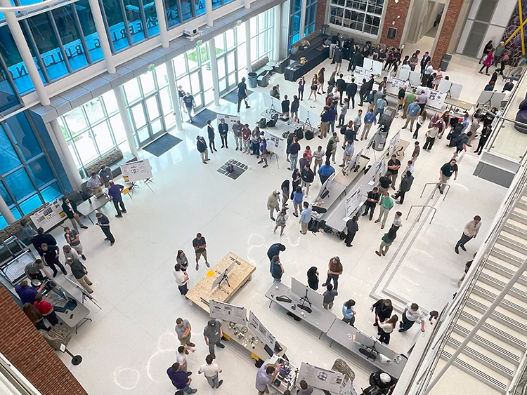 Looking down at the expo displays on the atrium floor from the 3rd floor of the Ashraf Islam Engineering Building