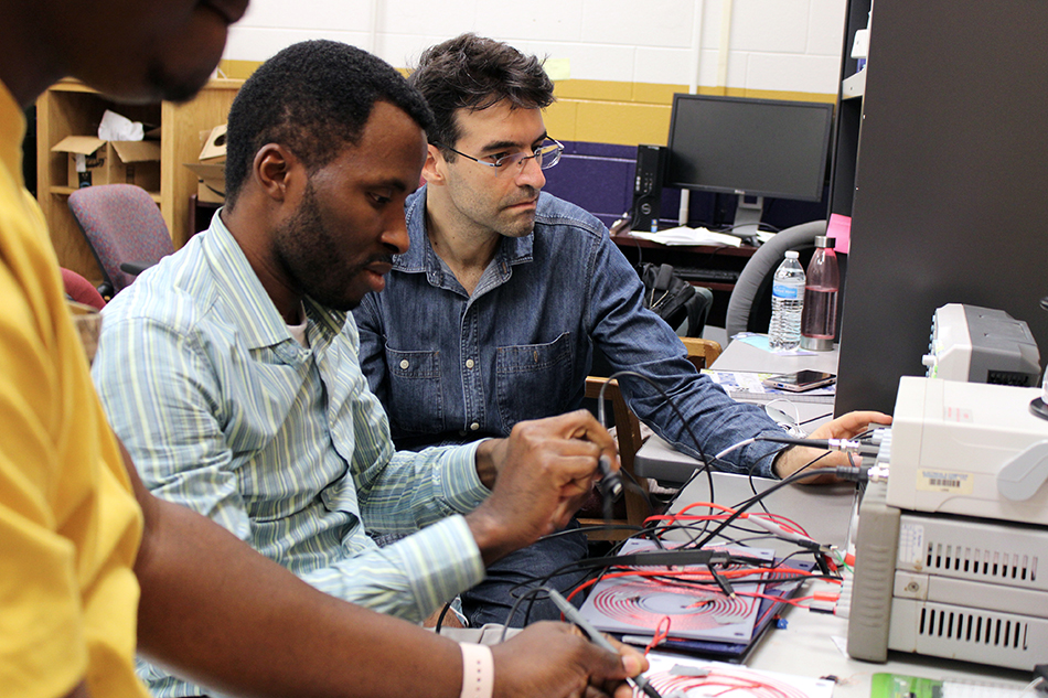 Electrical Engineering graduate students working in the lab