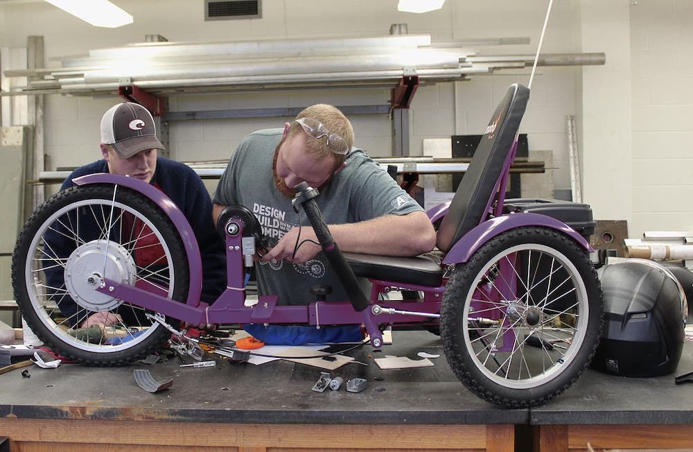 Two students working on a bike