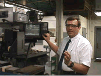 Computer Numerical Control instructor showing how a machine works
