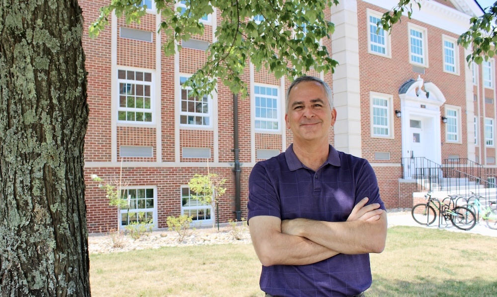 Dr. Bill Eberle stands near Bruner Hall