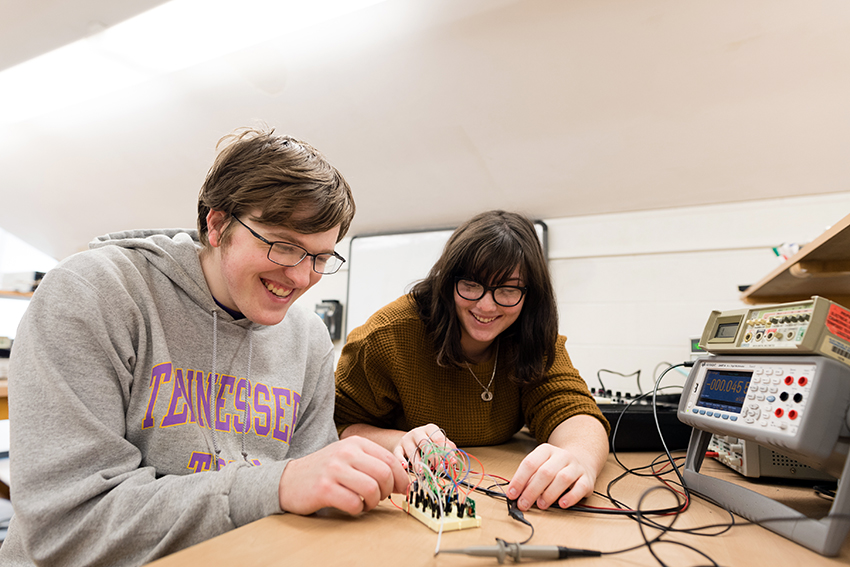Electrical and computer engineering students working in the lab