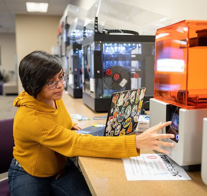 student using 3d printers in the iMakerSpace