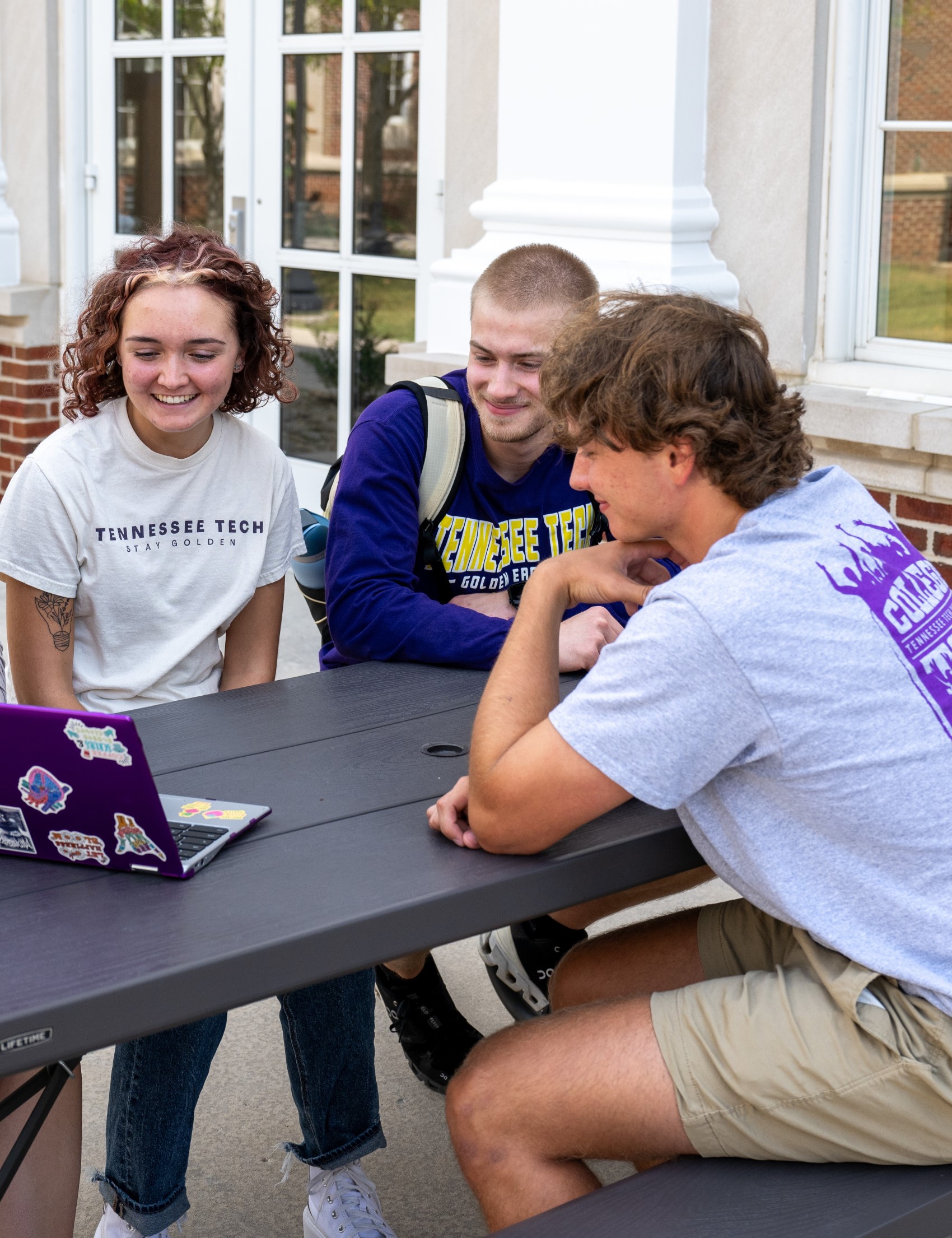 Students looking at laptop