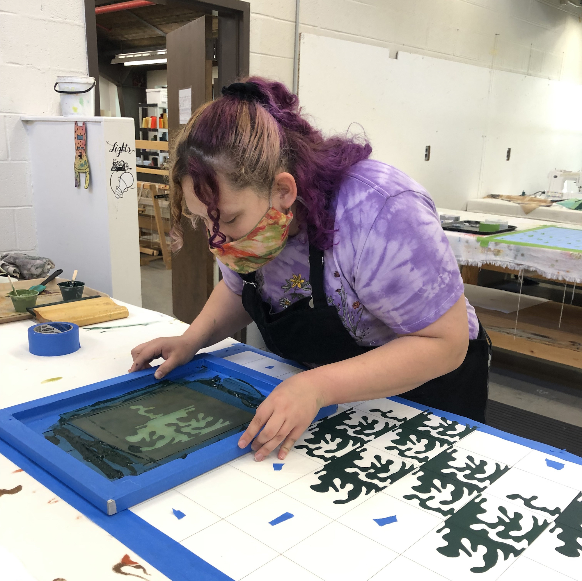 student painting a pattern