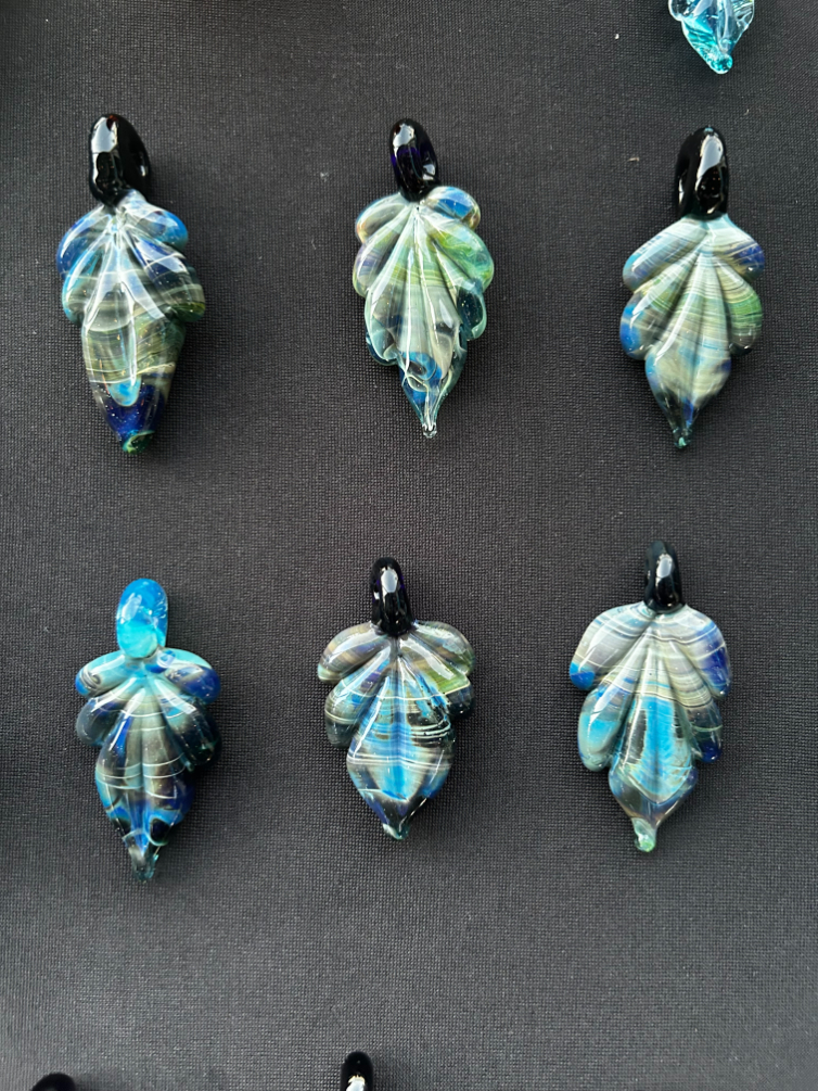 Small blue and green earrings made of glass of shapes of shells