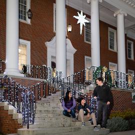 Group of students hanging out in front of Derryberry Hall with holiday lights around them. 