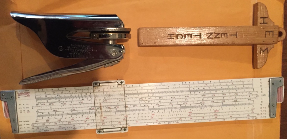 Bill's professional engineer seal, honor society t-square, and slide rule. 