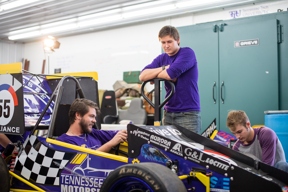 Students work on Formula SAE car.