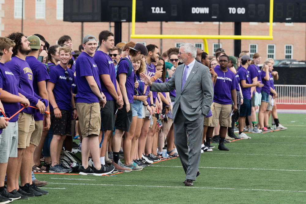 President Oldham welcomes new freshmen at the taking of the class photo.