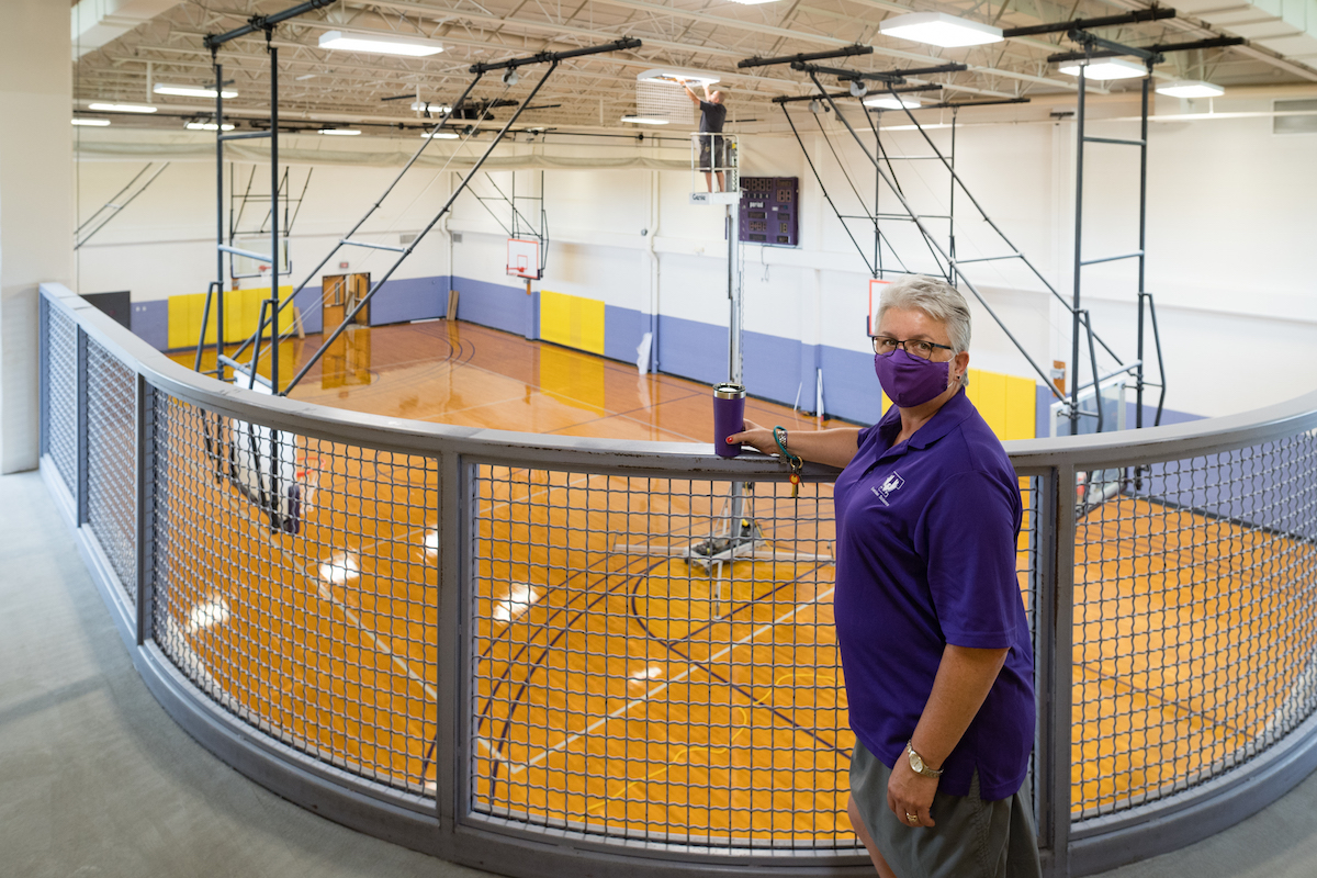 Christy Killman, chair of the exercise science department, and Marty Reeder, an electrician with campus facilities, work on renovating the old fitness center into the Academic Wellness Center.