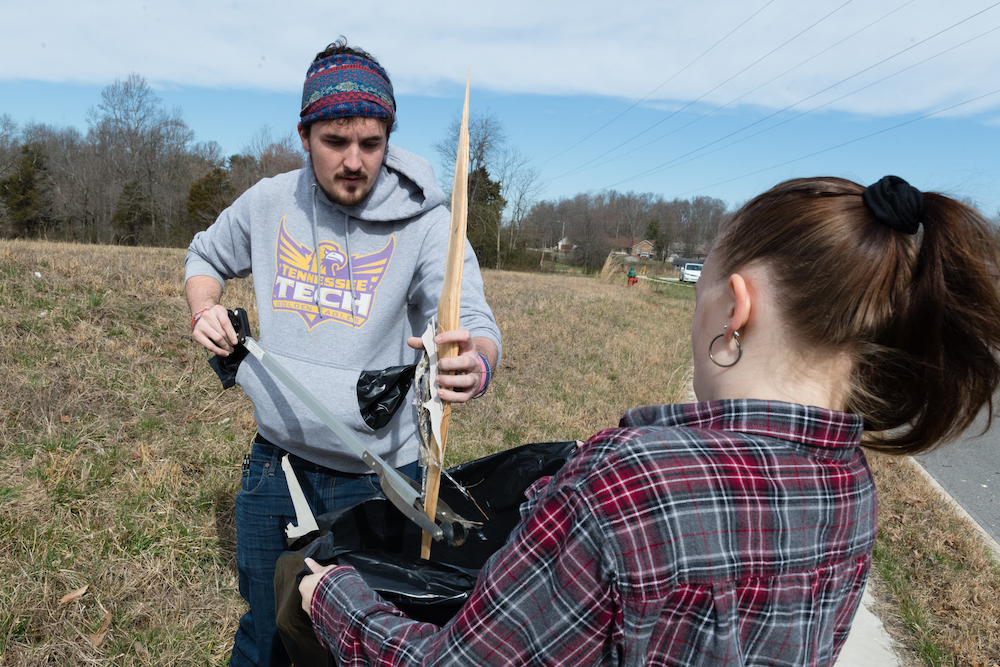 Tennessee Tech students Caleb Moss and Rebekah Chadwick help pick up debris on Wednesday.