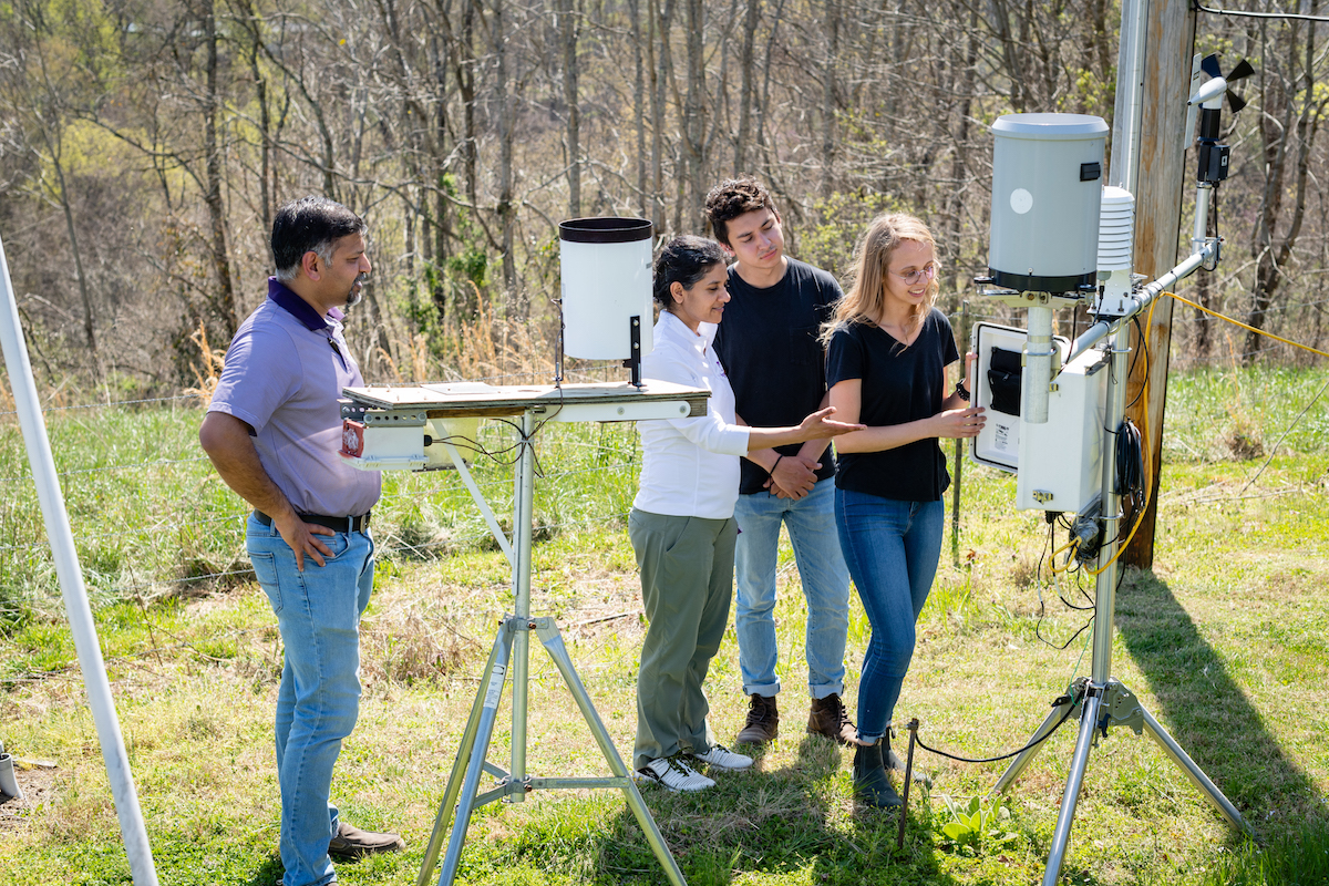 (From left) Alfred Kalyanapu and Tania Datta, associate professors in civil and environmental engineering, along with Tennessee Tech students Maci Arms and Thomas Harris look over weather data collected from sensors in Gainesboro.