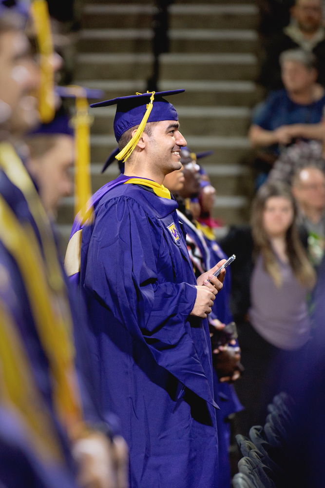 Students stand for applause at commencement ceremonies