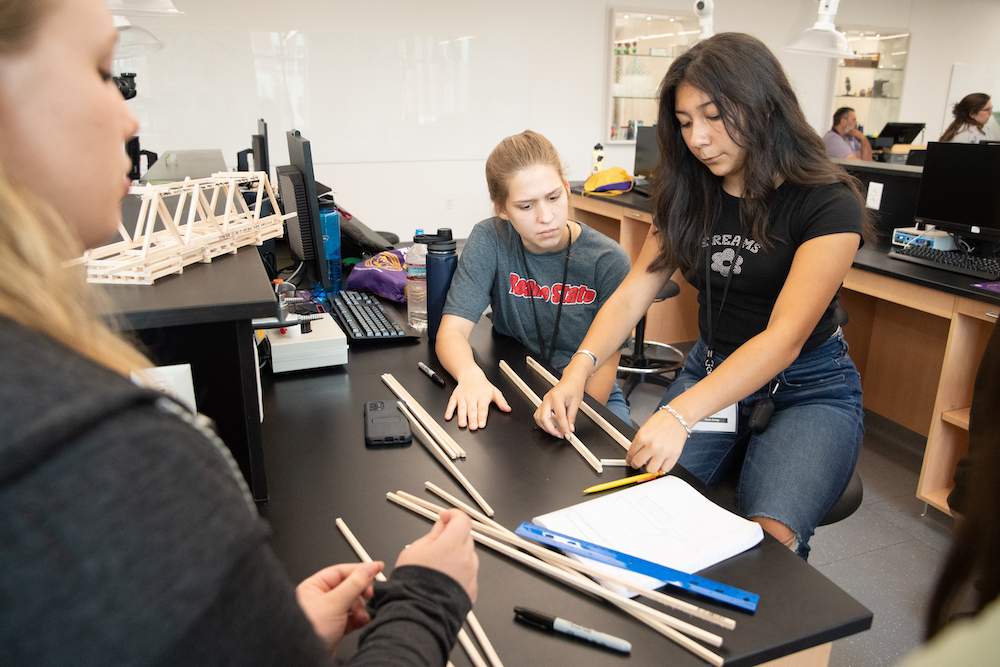 Eve Miclans, left, and Jazmyn Kirkland. Looking on is Sydney Osborn.