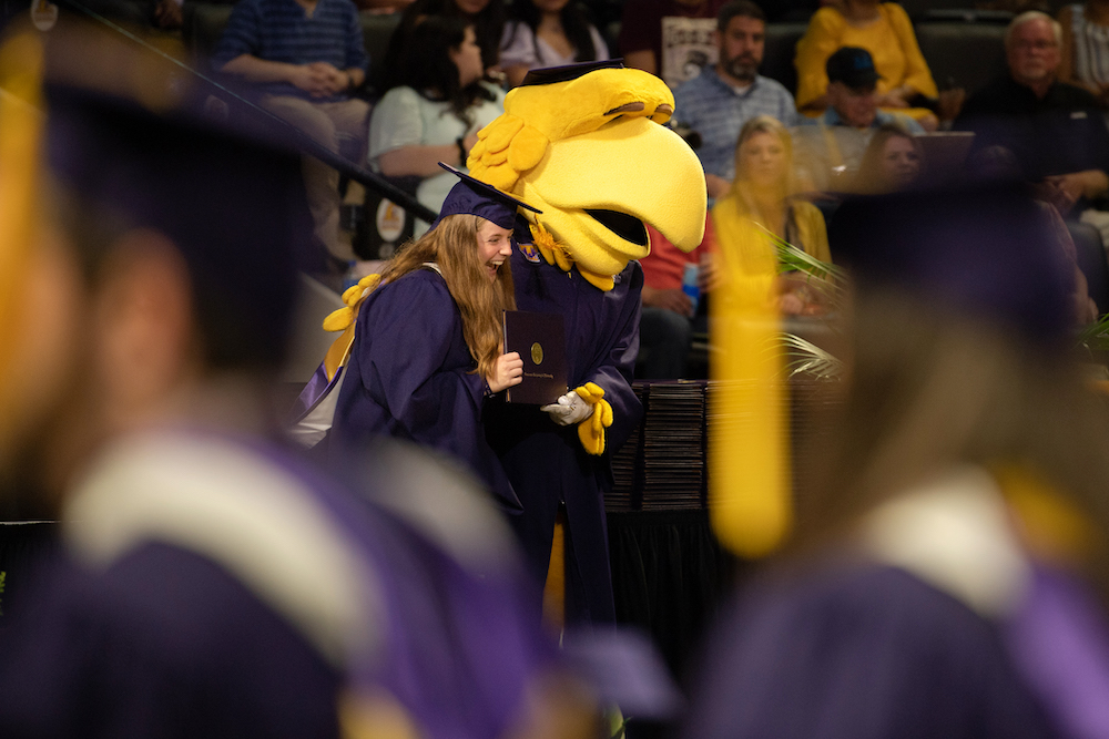 Awesome Eagle hugs a graduate