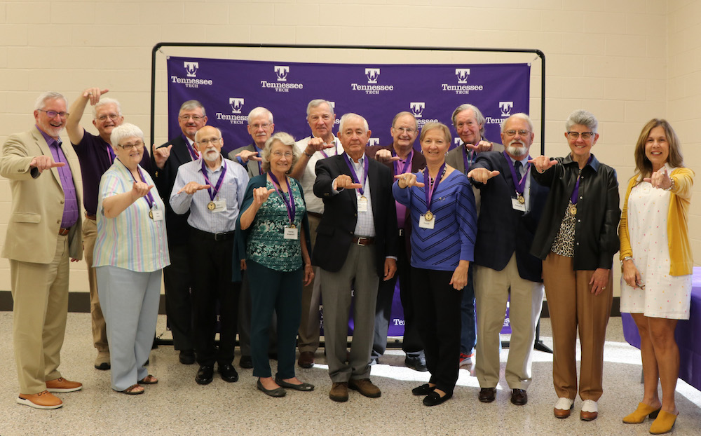 Members of the Class of 1972 give a wings up hand gesture.