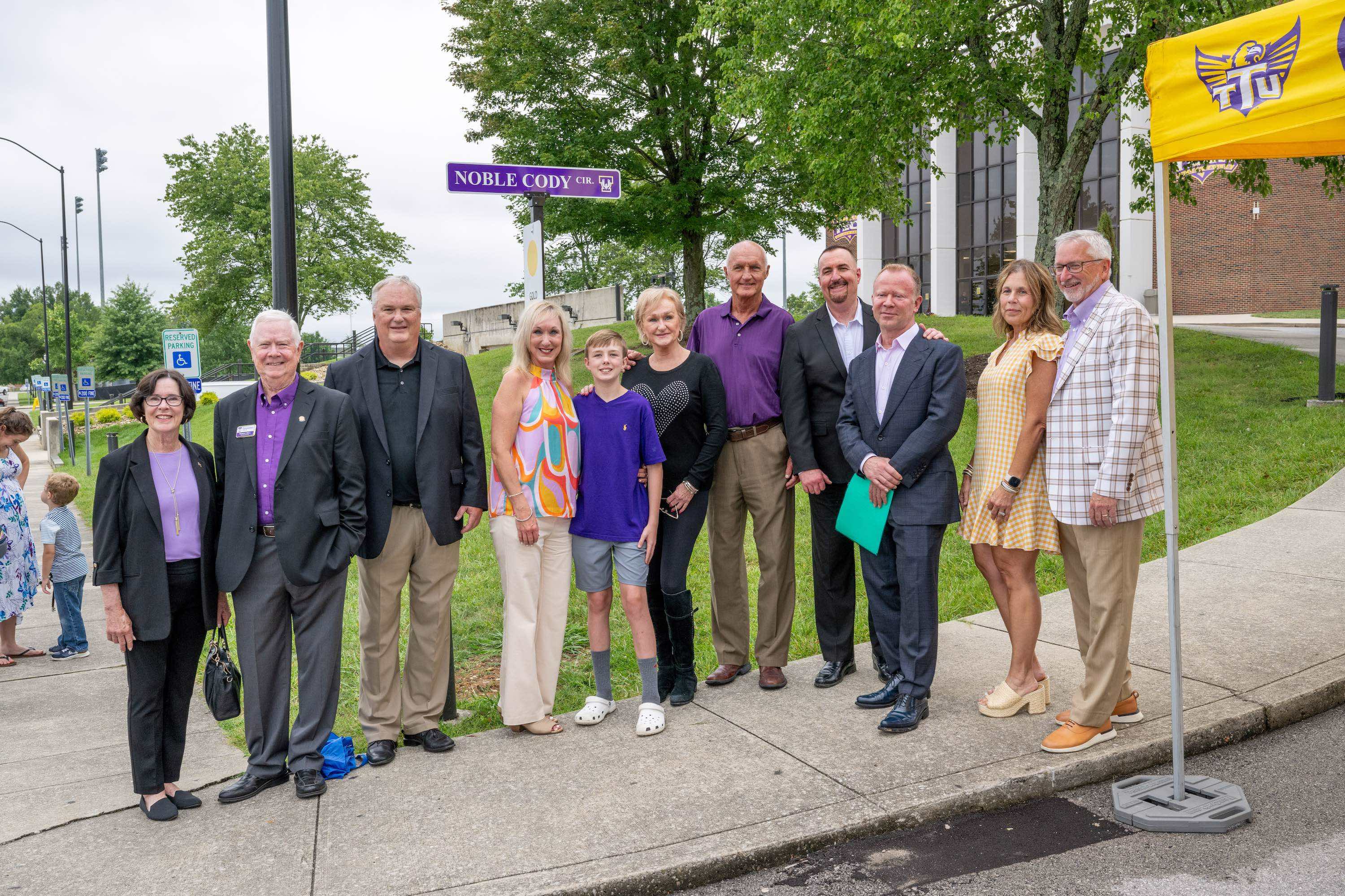 Members of the Cody family pictured with Tech President Phil Oldham, First Lady Kari Oldham, President Emeritus Bob Bell, former First Lady Gloria Bell, and longtime family friend Lewis Matheny at the newly named Noble Cody Circle. 