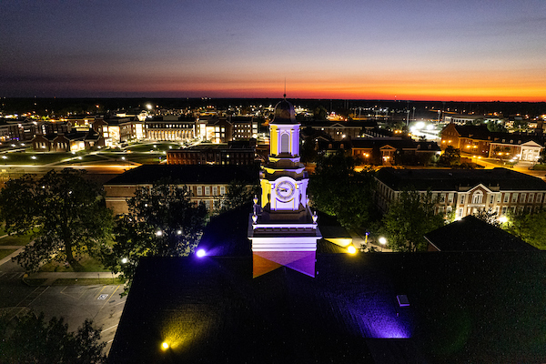 Tech's campus is seen at night with the cupola of Derryberry Hall in the foreground.