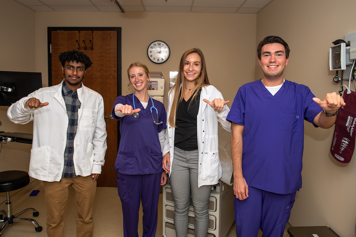 Nursing students at Tech give the "Wings Up" hand gesture.