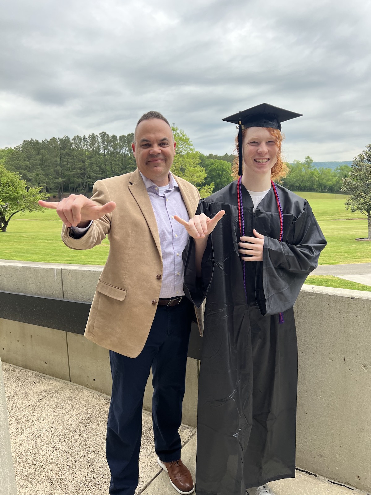 Director of Admissions at Tennessee Tech Frank Tittle and Roan to Tech graduate Richard Barnes flash a "wings up" gesture. 