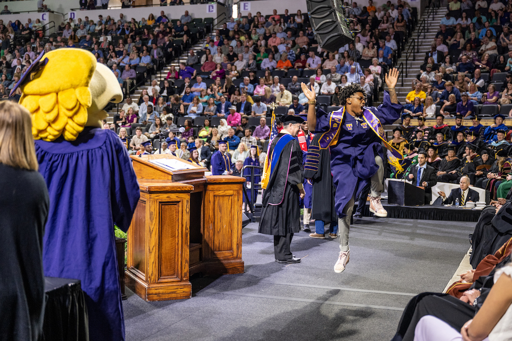 A graduate celebrates his new degree at Tech's spring 2023 commencement ceremony.