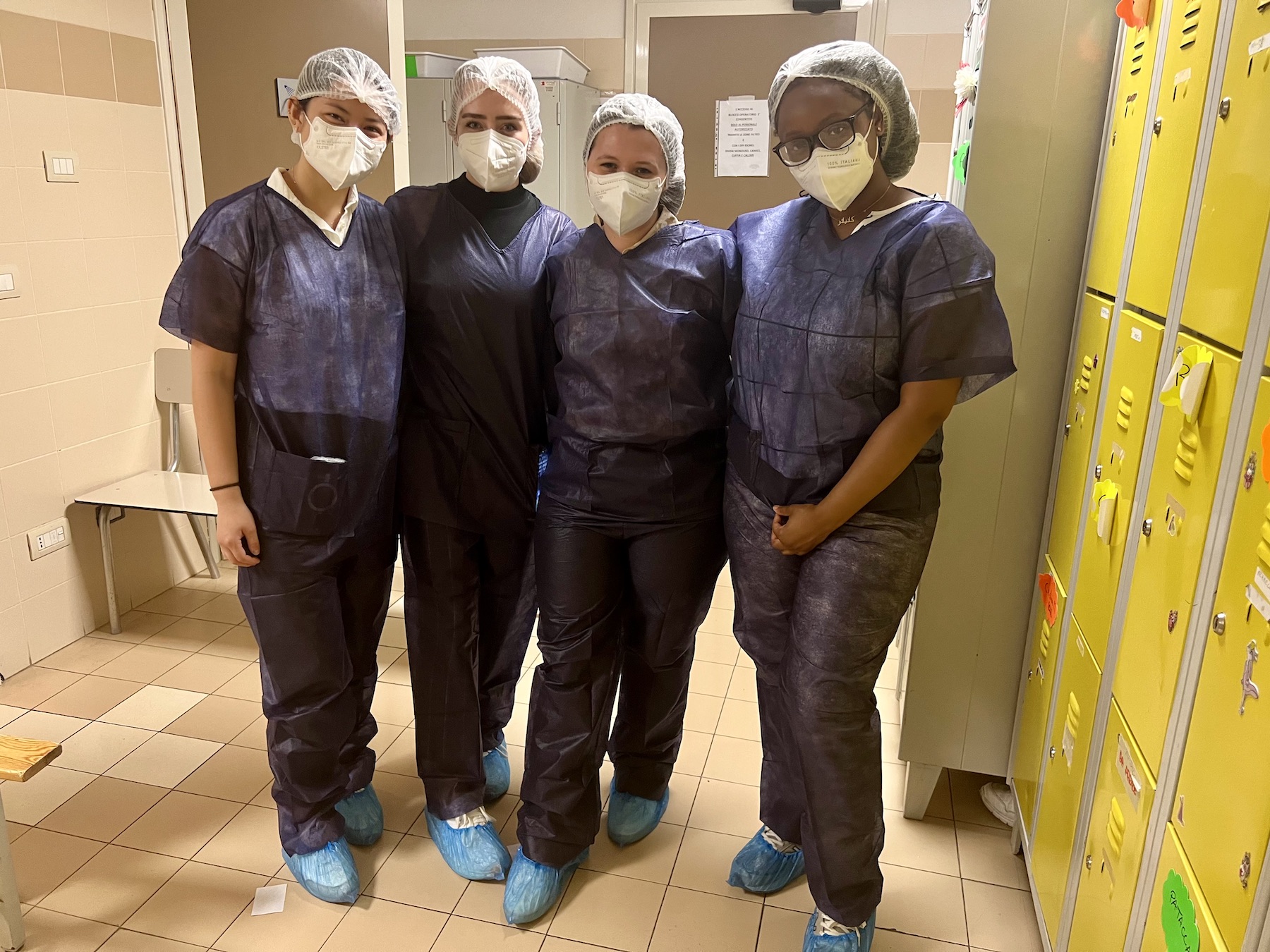 Tech students Jaycie Hitt (second from left) and Emma Carter (second from right) before they scrub in to assist with a surgery at an Italian hospital.