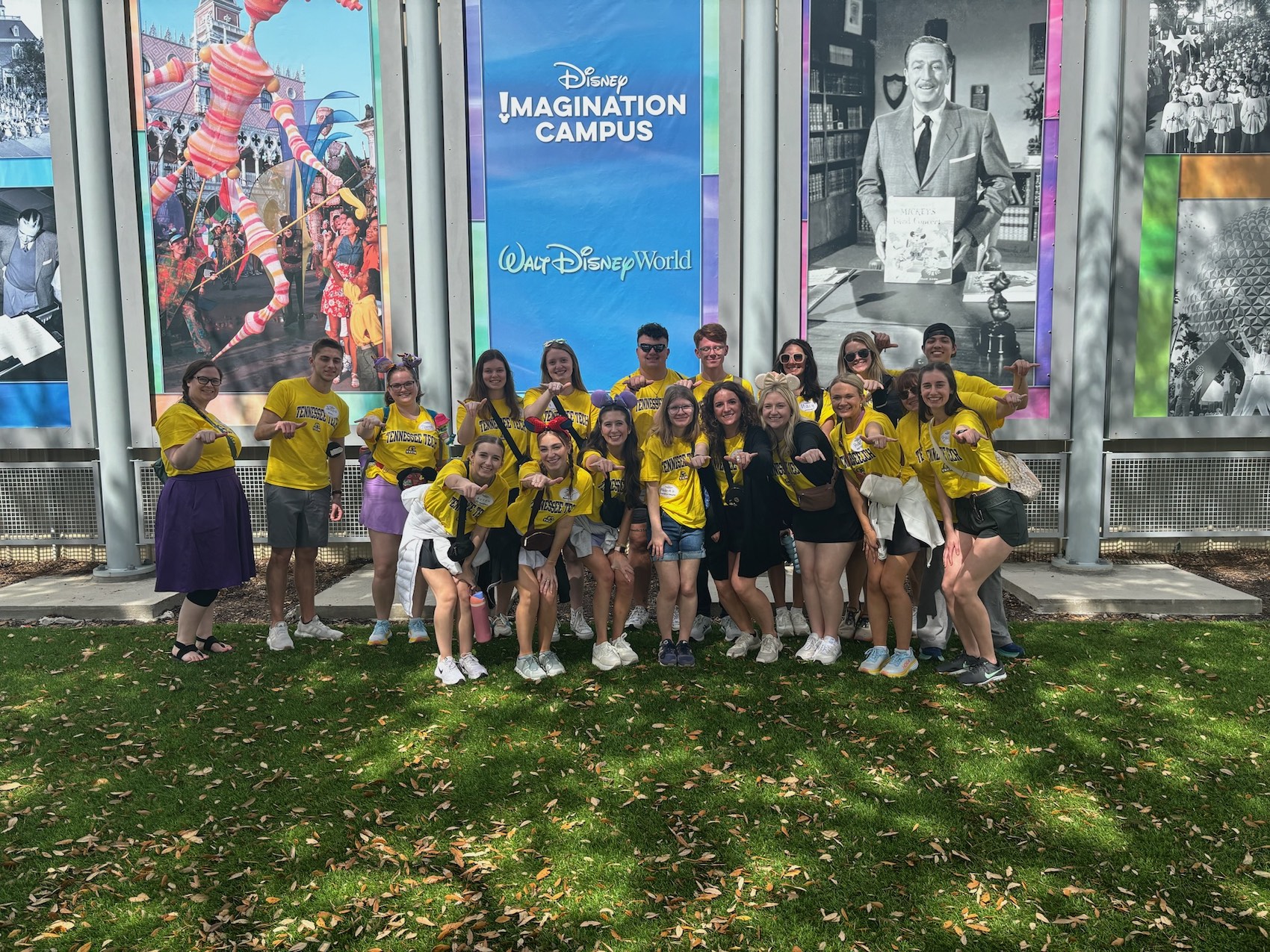 Students in Tech’s College of Business give a “Wings Up” hand signal outside the Disney Imagination Campus at Walt Disney World Resort. 