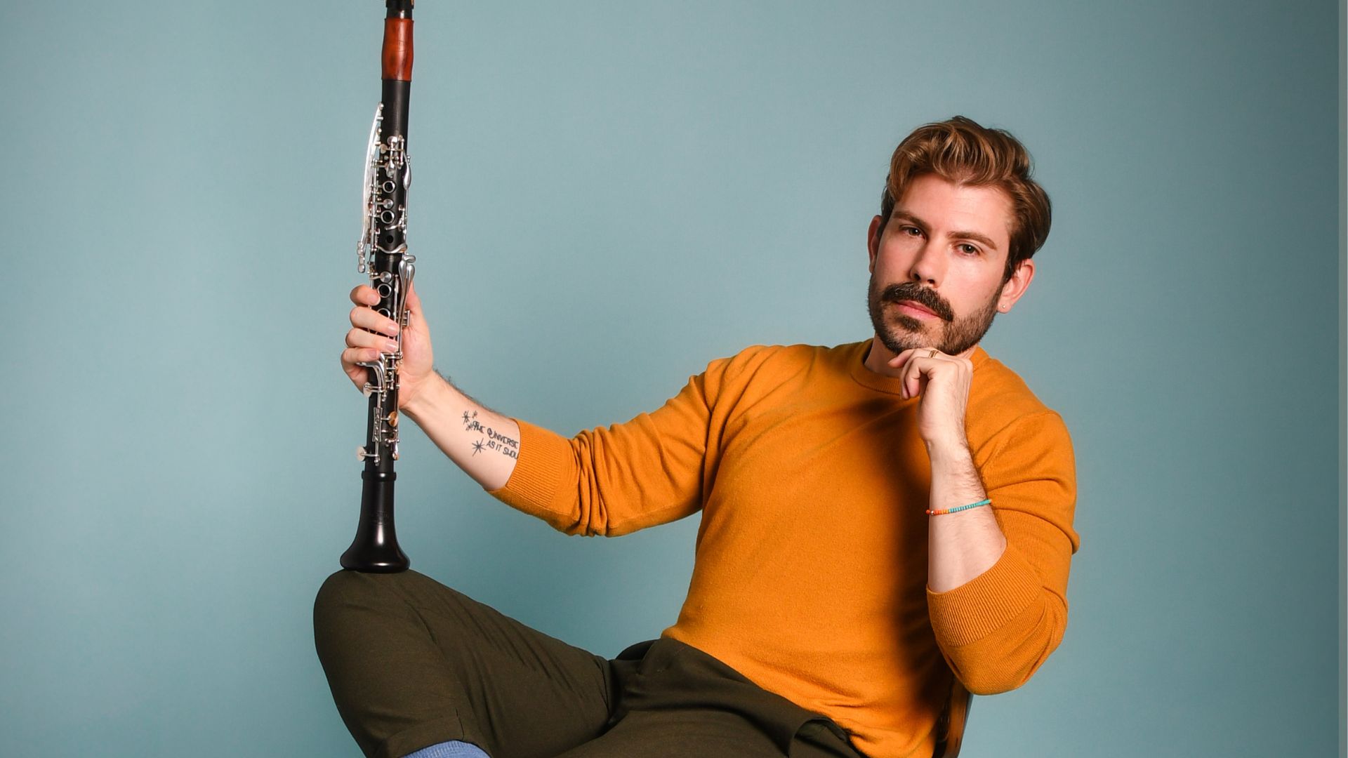 A headshot of Dr. Mark Cramer holding his clarinet