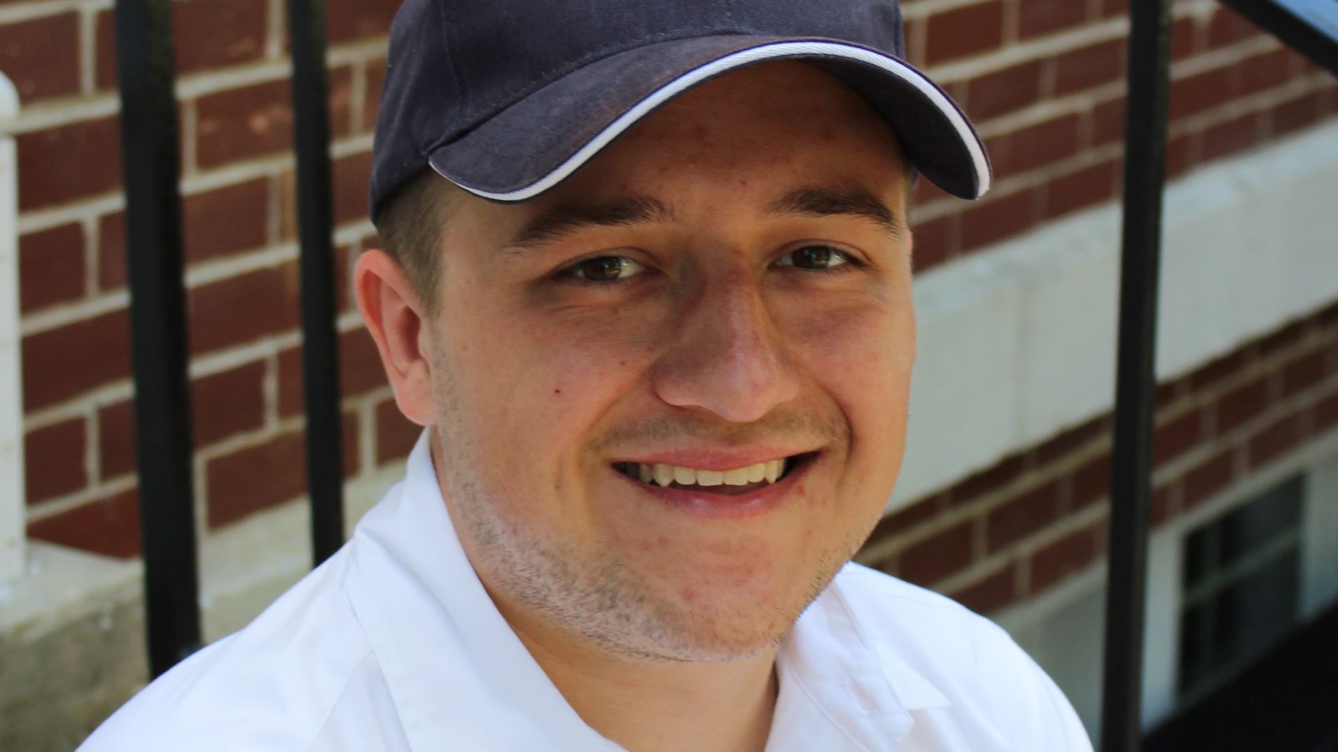 Tanner Cox wears a hat and smiles. 