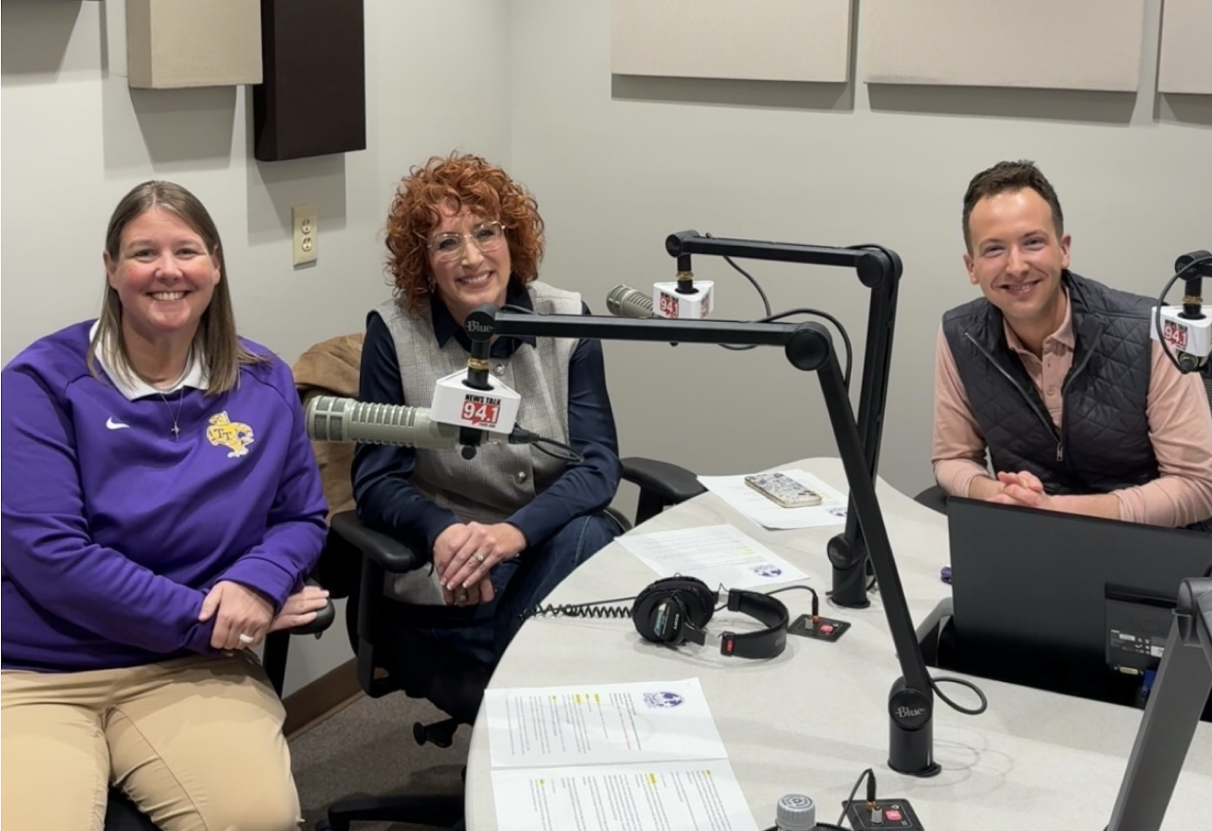 Jennifer Winningham and two others sit in a recording studio behind microphones.