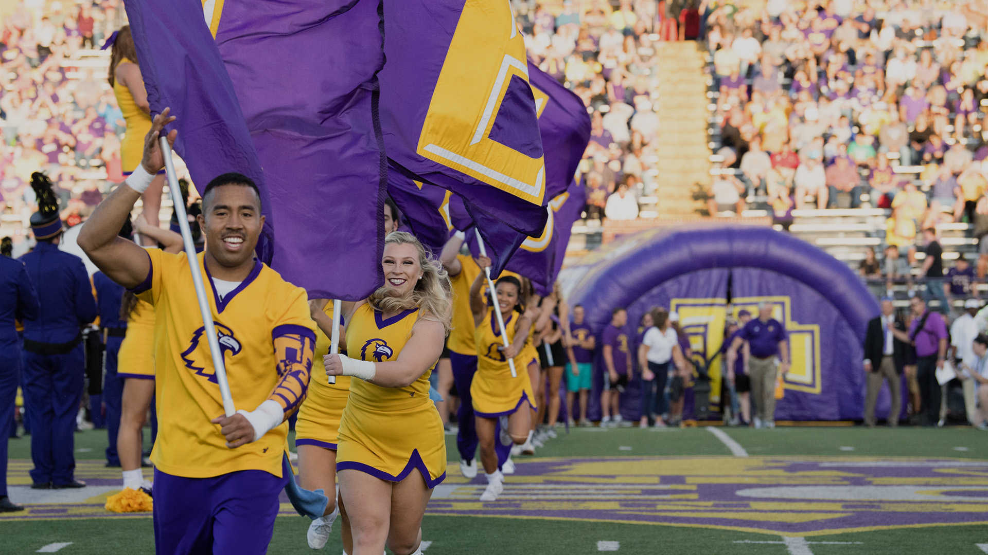Students running with Tennessee Tech banners