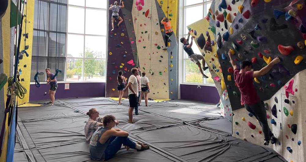 A group of students in the rock wall room at the Student Fitness Center.