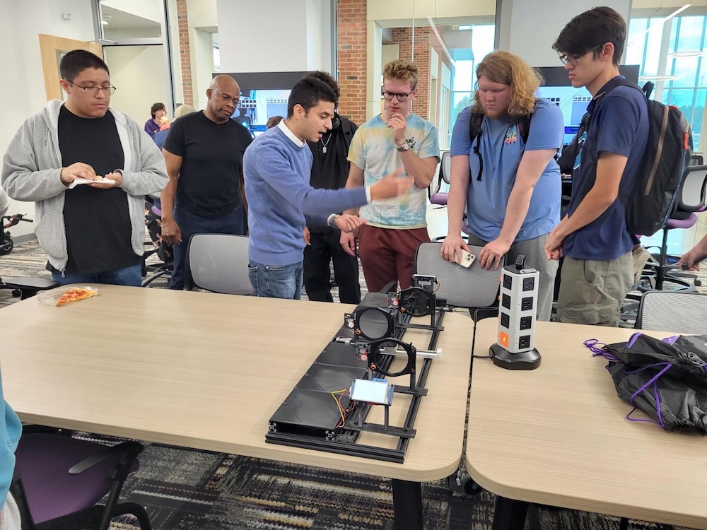 Quantum Discovery Day 2024 Students examine optical equipment for Quantum Discovery Day