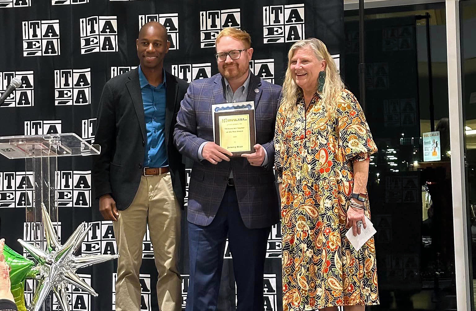 Jeremy Blair, center, associate professor of art education at Tennessee Tech, accepts the Art Education of the Year award from officials from the Tennessee Art Education Association.