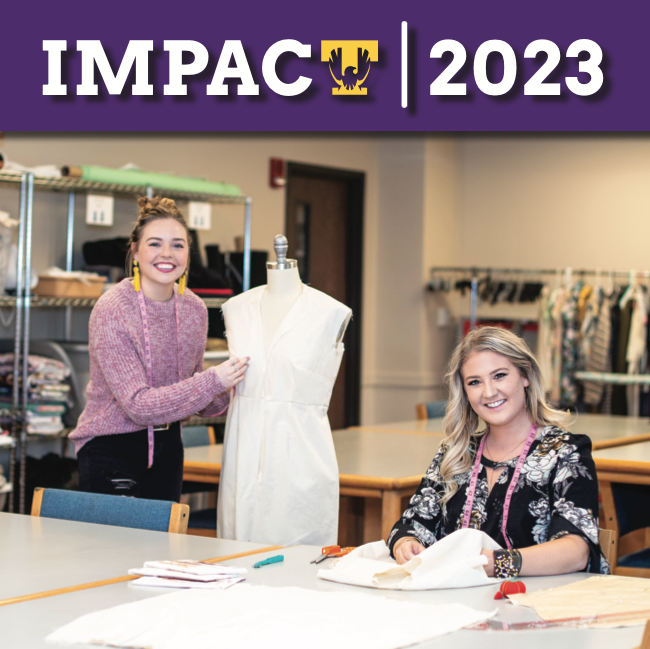 The cover of Impact - two students in a Human Ecology design lab