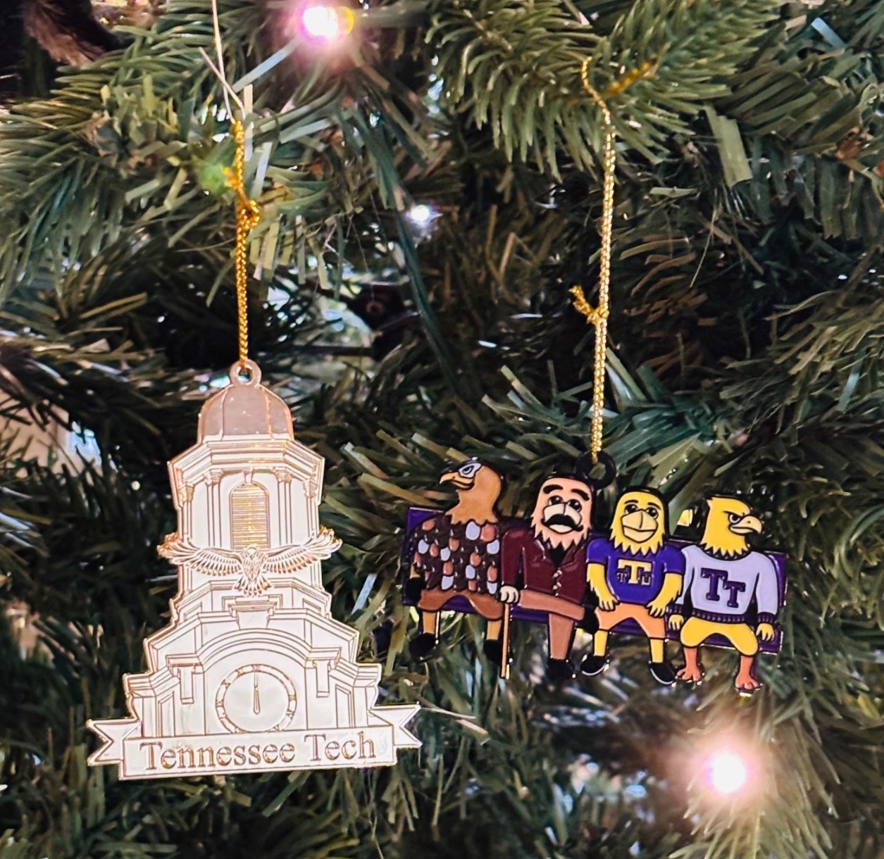 Derryberry Hall ornament and Tennessee Tech mascots through time ornament hanging in a tree