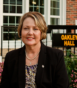 Tawnya Robinson-Moss in front of Oakley Hall