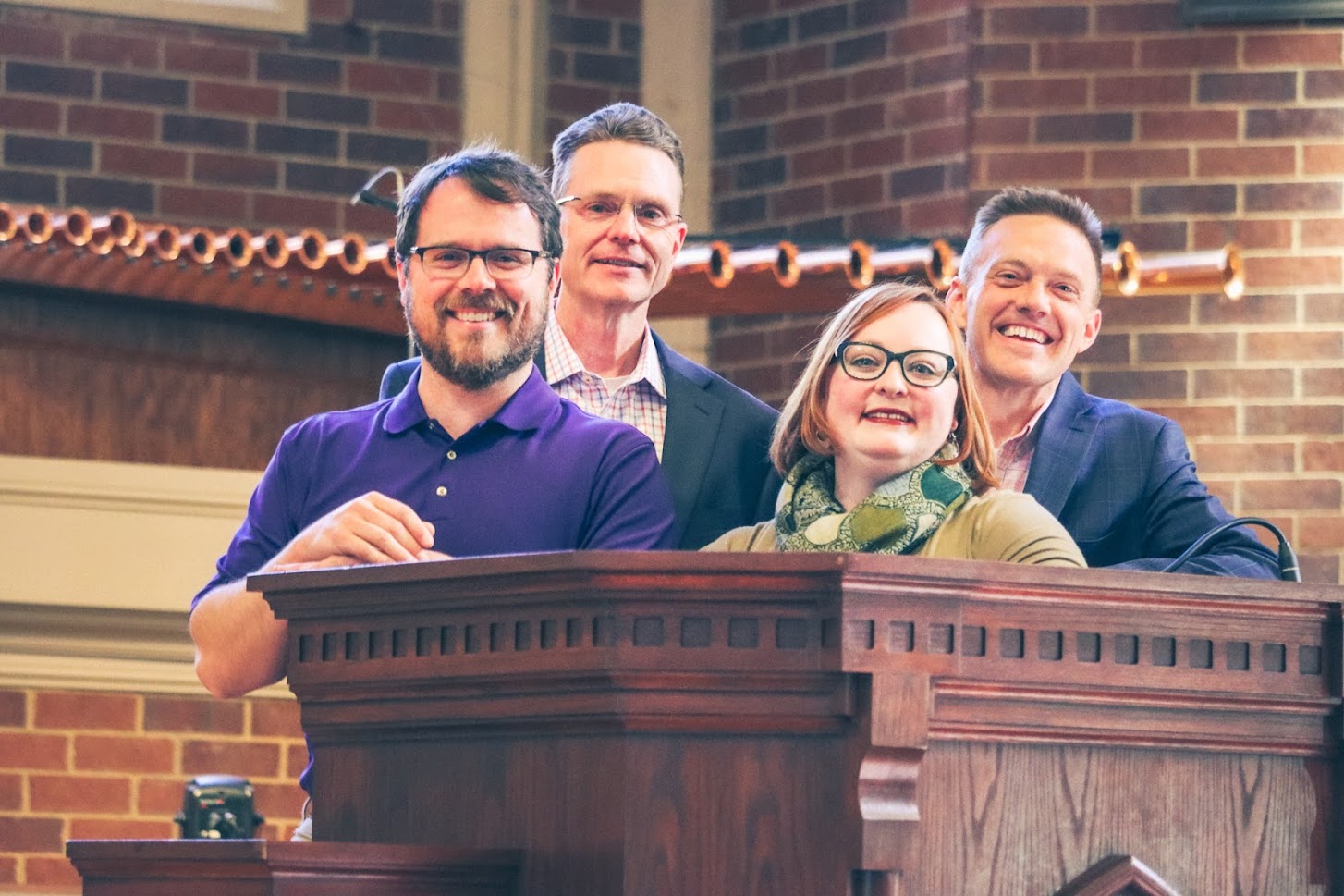 The four Tech alumni employed by FUMC standing in the church.