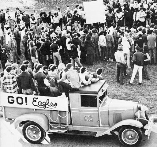 a black and white photo of a crowd at a pep rally during Homecoming week in 1970.