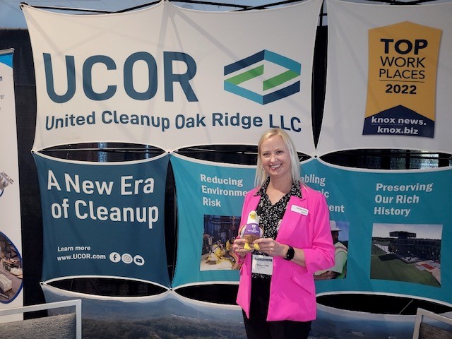 Shannon Potter in front of a UCOR sign