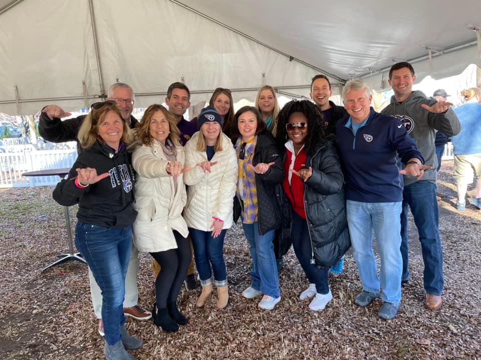 President and Mrs. Oldham smile with members of the Alumni Association Board and Crawford Alumni Center staff at the tailgate