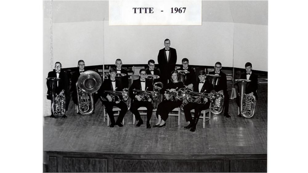 A 1967 photo of the tuba ensemble seated with their instruments
